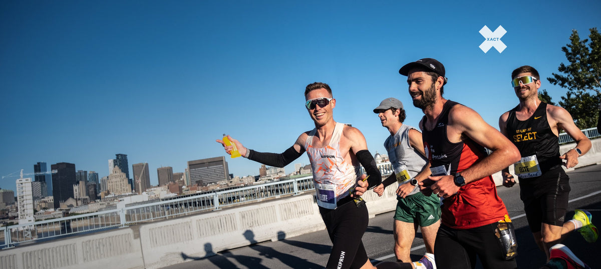 Runners on the Jacques-Cartier Bridge at the Marathon Beneva de Montréal, with the city skyline behind them